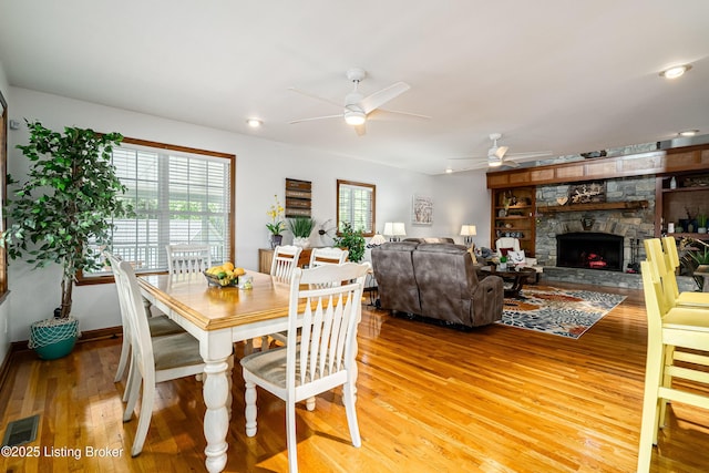 309 Clarks Ln, Clarkson, KY 42726 - dining room featuring light wood-style flooring, a ceiling fan, and a fireplace