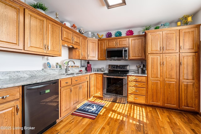 309 Clarks Ln, Clarkson, KY 42726 - kitchen with appliances with stainless steel finishes, light wood finished floors, and brown cabinets