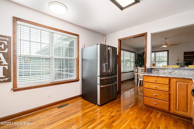 309 Clarks Ln, Clarkson, KY 42726 - kitchen featuring stainless steel refrigerator with ice dispenser, light wood-type flooring, brown cabinets, and a ceiling fan