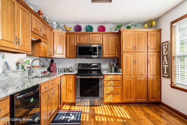 309 Clarks Ln, Clarkson, KY 42726 - kitchen with appliances with stainless steel finishes, light wood-style floors, plenty of natural light, and light stone counters