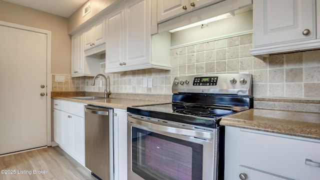 4720 Ferrer Way, Jeffersontown, KY 40299 - kitchen featuring stainless steel appliances, white cabinets, backsplash, light wood finished floors, and light stone countertops