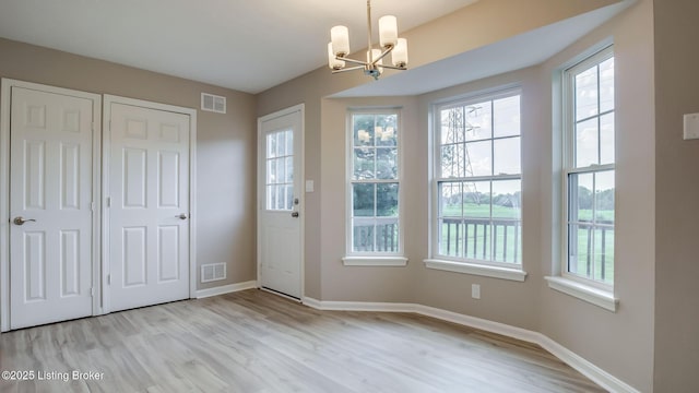 4720 Ferrer Way, Jeffersontown, KY 40299 - doorway to outside featuring a chandelier, wood finished floors, and plenty of natural light