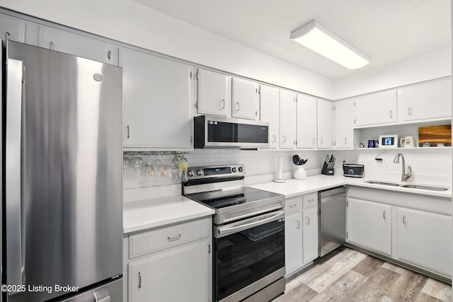 111 La Fontenay Ct, Louisville, KY 40223 - kitchen with appliances with stainless steel finishes, decorative backsplash, light wood finished floors, light countertops, and white cabinetry