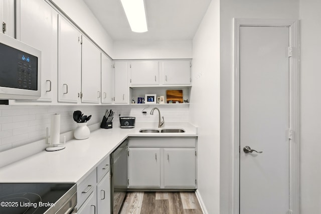 111 La Fontenay Ct, Louisville, KY 40223 - kitchen featuring appliances with stainless steel finishes, backsplash, light wood-style flooring, and light countertops