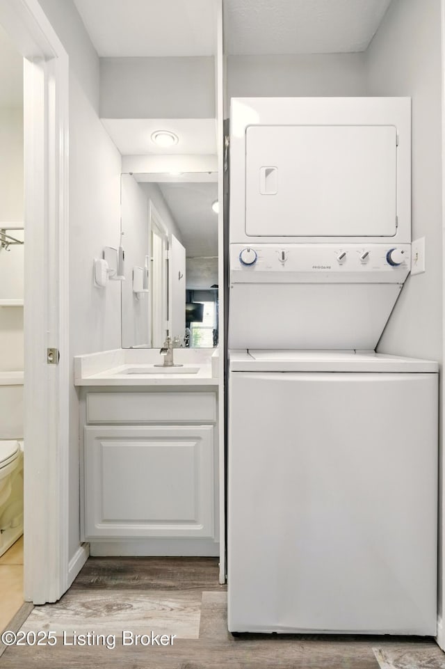 111 La Fontenay Ct, Louisville, KY 40223 - laundry room with stacked washer and clothes dryer and wood finished floors