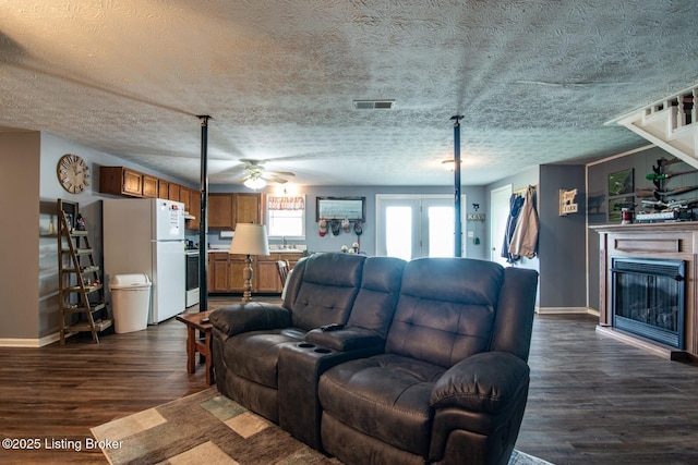 2923 High Plains Rd, Vine Grove, KY 40175 - living room with dark wood-style floors, ceiling fan, a glass covered fireplace, a textured ceiling, and stairs