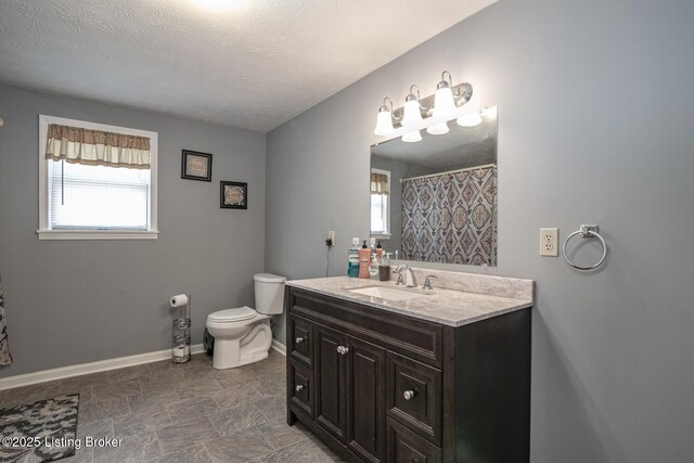 2923 High Plains Rd, Vine Grove, KY 40175 - bathroom with vanity, plenty of natural light, a textured ceiling, and stone finish floors