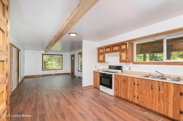 1465 Swope Rd, Owenton, KY 40359 - kitchen featuring gas range oven, light countertops, beam ceiling, dark wood-style floors, and brown cabinetry