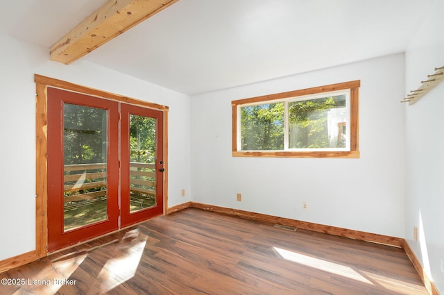 1465 Swope Rd, Owenton, KY 40359 - empty room with healthy amount of natural light, wood finished floors, and beamed ceiling