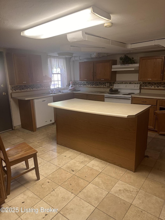 126 Taylorsville Rd, Bloomfield, KY 40008 - kitchen with white appliances, decorative backsplash, under cabinet range hood, light countertops, and brown cabinetry