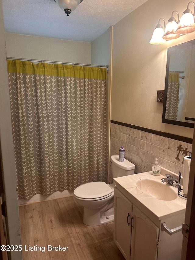 126 Taylorsville Rd, Bloomfield, KY 40008 - bathroom with tile walls, vanity, wood finished floors, a wainscoted wall, and curtained shower