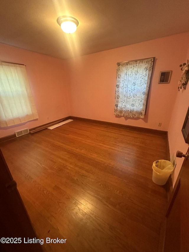 126 Taylorsville Rd, Bloomfield, KY 40008 - unfurnished room featuring wood finished floors and a baseboard heating unit