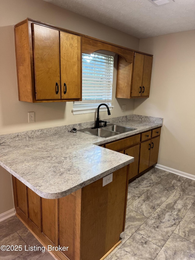 106 Clay Ct, Bardstown, KY 40004 - kitchen with a peninsula, light countertops, brown cabinets, and a textured ceiling