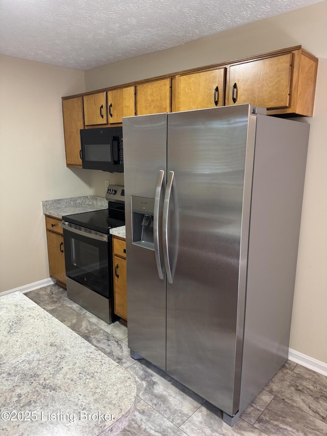 106 Clay Ct, Bardstown, KY 40004 - kitchen featuring appliances with stainless steel finishes, brown cabinets, light countertops, and a textured ceiling