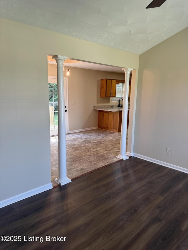 106 Clay Ct, Bardstown, KY 40004 - empty room with decorative columns and dark wood-type flooring