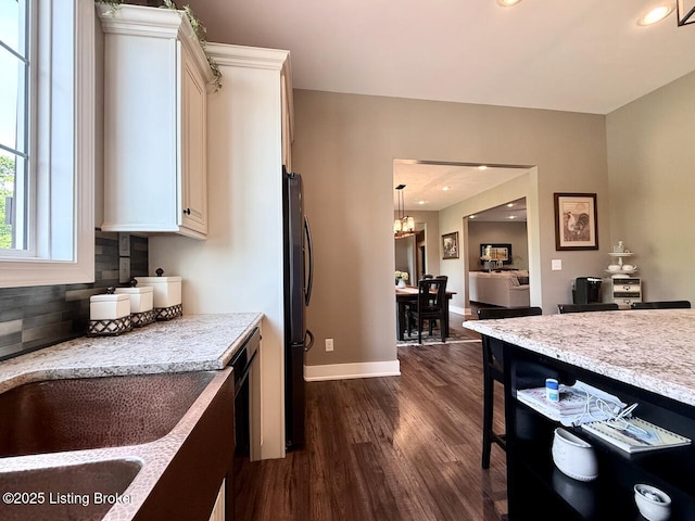 3637 Mount Washington Rd, Taylorsville, KY 40071 - kitchen with freestanding refrigerator, dark wood-type flooring, decorative backsplash, a chandelier, and white cabinetry