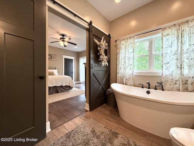 3637 Mount Washington Rd, Taylorsville, KY 40071 - full bath with a soaking tub, wood finished floors, a ceiling fan, and recessed lighting