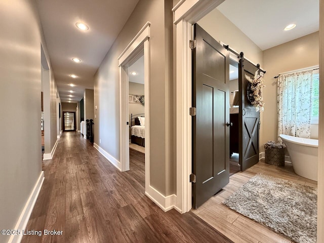 3637 Mount Washington Rd, Taylorsville, KY 40071 - corridor with dark wood-style floors, a barn door, and recessed lighting