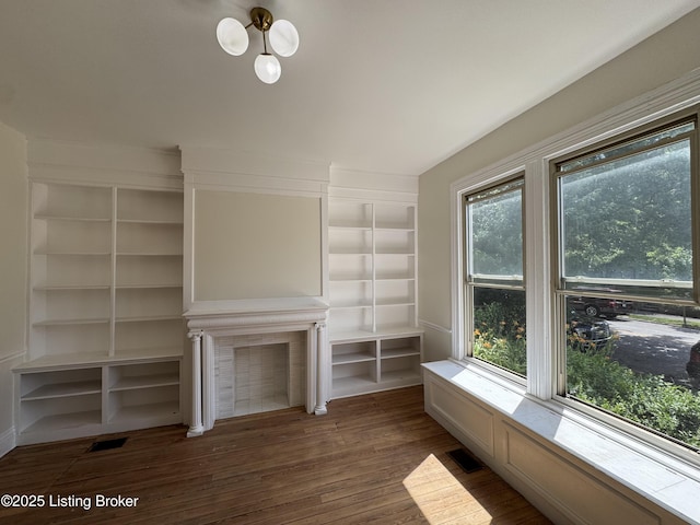 1403 S Brook St, Louisville, KY 40208 - unfurnished living room with built in features, wood finished floors, a chandelier, and a fireplace
