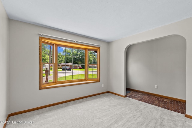 7502 Sam Ct, Louisville, KY 40214 - spare room with carpet flooring and arched walkways