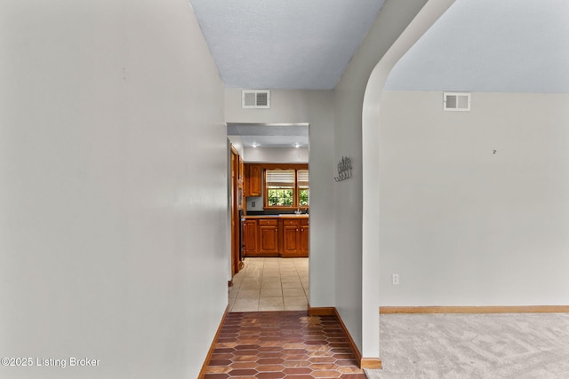 7502 Sam Ct, Louisville, KY 40214 - hallway with arched walkways and light tile patterned flooring