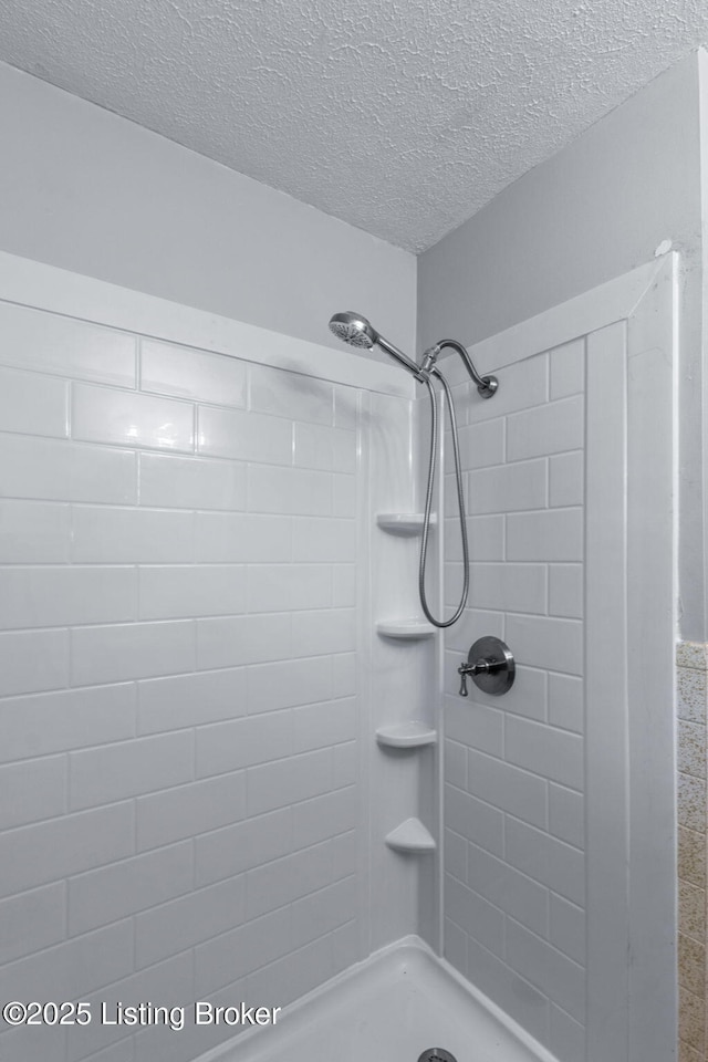 7502 Sam Ct, Louisville, KY 40214 - full bath featuring a textured ceiling and tiled shower