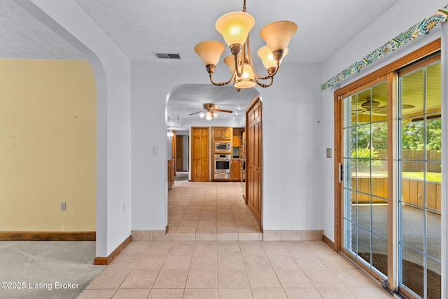 7502 Sam Ct, Louisville, KY 40214 - corridor featuring arched walkways, light tile patterned floors, and a chandelier