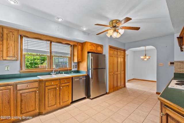 7502 Sam Ct, Louisville, KY 40214 - kitchen featuring stainless steel appliances, a chandelier, brown cabinets, arched walkways, and ceiling fan