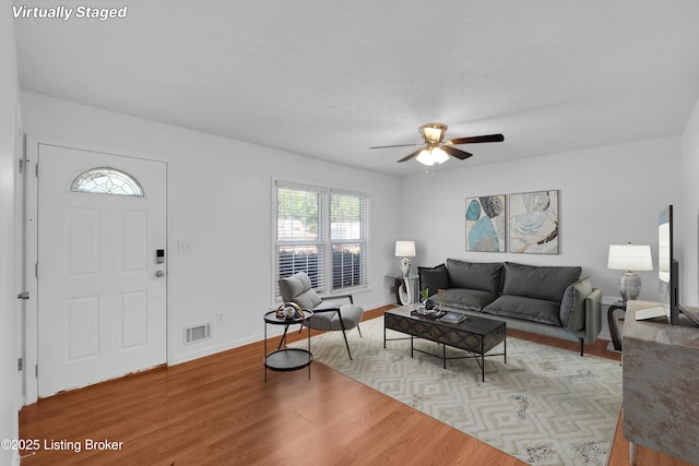 8313 Daverman Dr, Louisville, KY 40228 - living area with light wood-style flooring, ceiling fan, and healthy amount of natural light