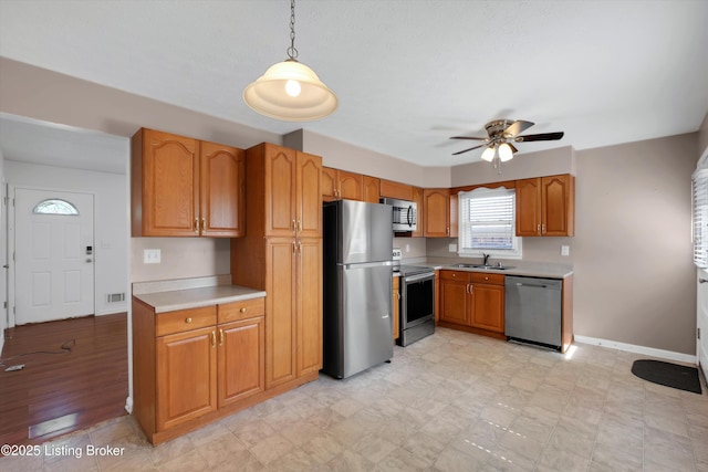 8313 Daverman Dr, Louisville, KY 40228 - kitchen with appliances with stainless steel finishes, light countertops, a ceiling fan, and decorative light fixtures