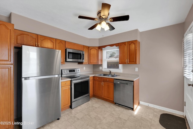 8313 Daverman Dr, Louisville, KY 40228 - kitchen featuring stainless steel appliances, light countertops, a ceiling fan, and brown cabinetry