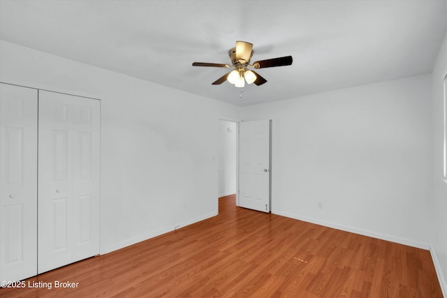 8313 Daverman Dr, Louisville, KY 40228 - unfurnished bedroom with light wood-style floors, a closet, and a ceiling fan