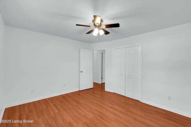 8313 Daverman Dr, Louisville, KY 40228 - unfurnished bedroom with light wood finished floors, a closet, and ceiling fan