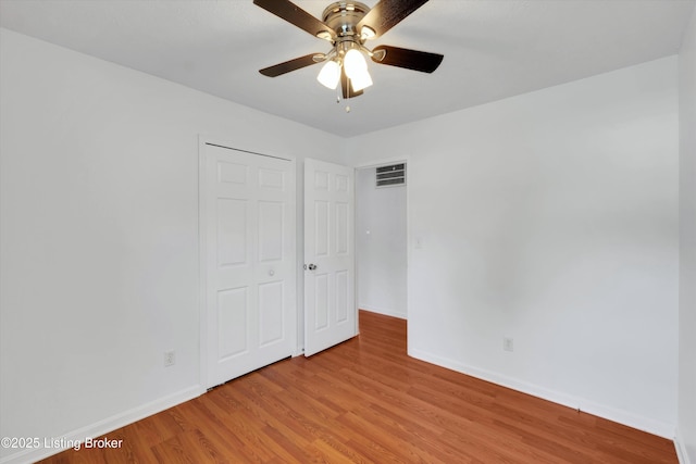 8313 Daverman Dr, Louisville, KY 40228 - unfurnished bedroom with light wood-style floors, ceiling fan, and a closet