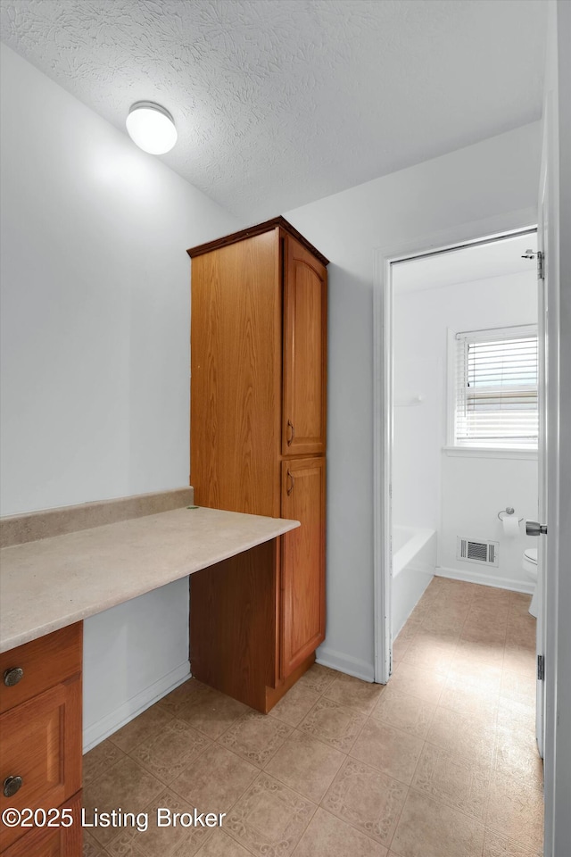 8313 Daverman Dr, Louisville, KY 40228 - unfurnished office featuring built in desk and a textured ceiling