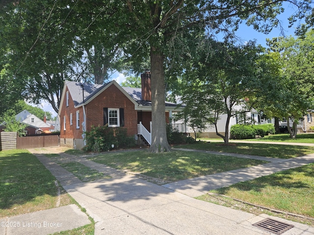 3919 Staebler Ave, Louisville, KY 40207 - view of front of home with brick siding and a chimney