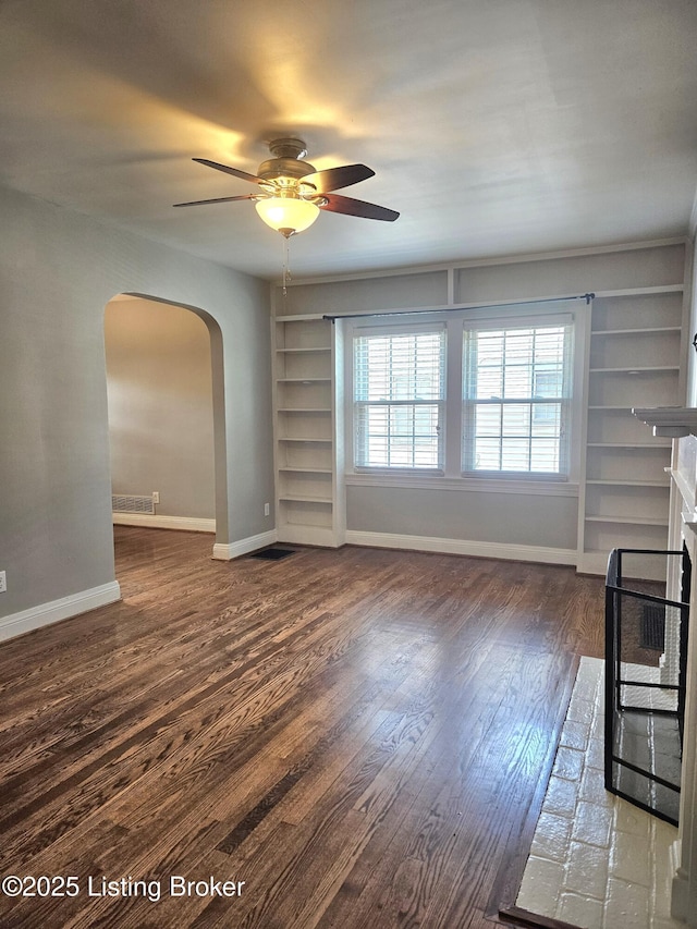 3919 Staebler Ave, Louisville, KY 40207 - unfurnished living room with built in features, arched walkways, ceiling fan, wood finished floors, and a fireplace