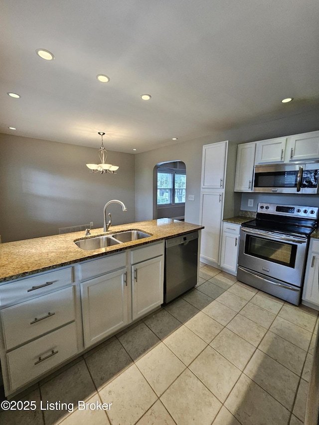 3919 Staebler Ave, Louisville, KY 40207 - kitchen featuring stainless steel appliances, light stone countertops, white cabinetry, a chandelier, and recessed lighting