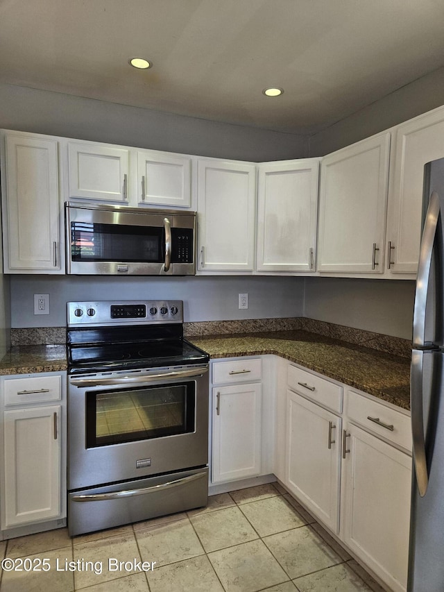 3919 Staebler Ave, Louisville, KY 40207 - kitchen with appliances with stainless steel finishes, white cabinetry, light tile patterned floors, recessed lighting, and dark stone countertops