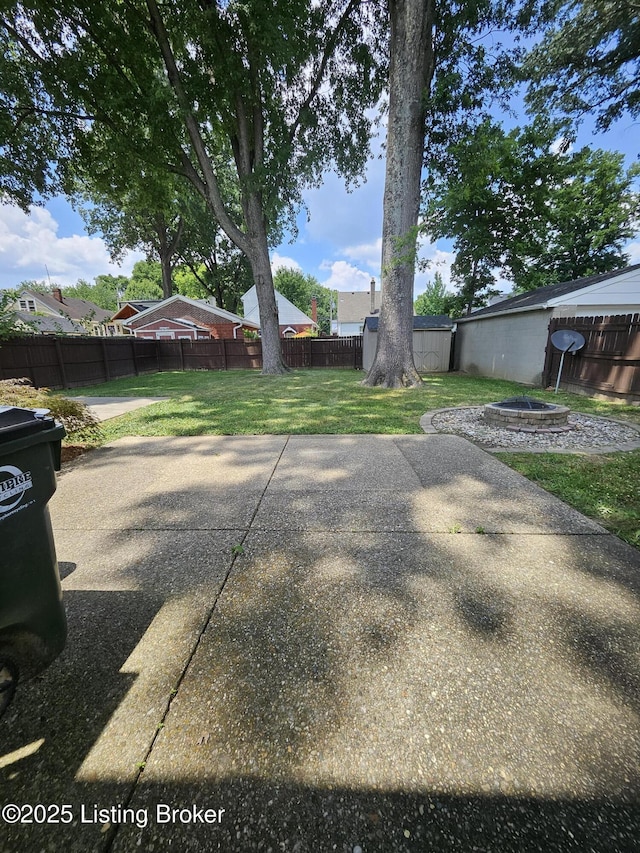 3919 Staebler Ave, Louisville, KY 40207 - fenced backyard featuring an outdoor fire pit and a patio
