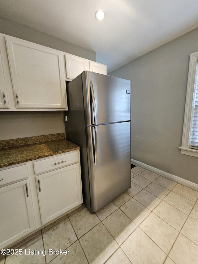 3919 Staebler Ave, Louisville, KY 40207 - kitchen featuring freestanding refrigerator, white cabinetry, light tile patterned flooring, recessed lighting, and dark stone counters