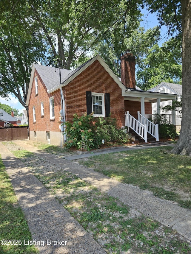 3919 Staebler Ave, Louisville, KY 40207 - view of front of house featuring brick siding, a chimney, and a porch