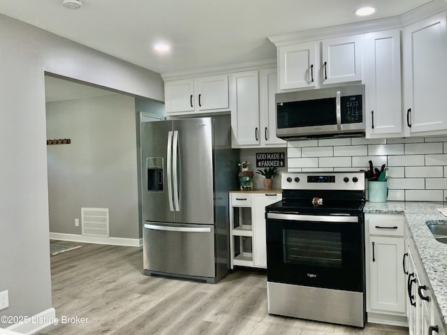 444 Lagrange Rd, New Castle, KY 40050 - kitchen with stainless steel appliances, white cabinetry, tasteful backsplash, light wood finished floors, and recessed lighting