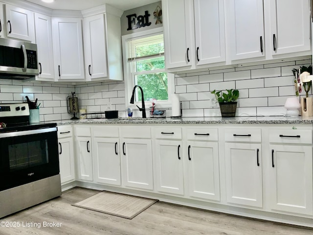 444 Lagrange Rd, New Castle, KY 40050 - kitchen featuring stainless steel appliances, white cabinetry, decorative backsplash, and light stone counters