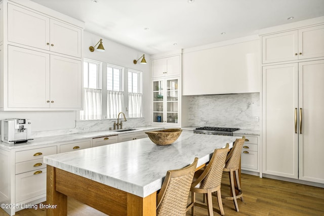 6115 Passionflower Dr, Prospect, KY 40059 - kitchen with backsplash, white cabinetry, light wood finished floors, a breakfast bar, and a center island