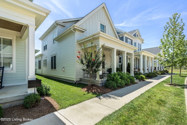 6115 Passionflower Dr, Prospect, KY 40059 - view of side of property with covered porch, board and batten siding, and a lawn