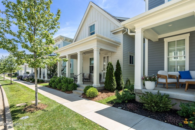 6115 Passionflower Dr, Prospect, KY 40059 - view of home's exterior with a porch, board and batten siding, and a yard