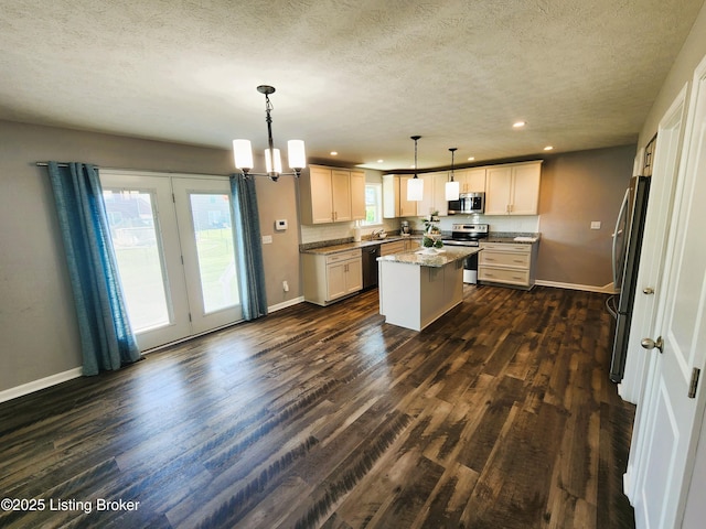12630 Orell Station Pl, Louisville, KY 40272 - kitchen featuring appliances with stainless steel finishes, recessed lighting, dark wood-style floors, a kitchen island, and a textured ceiling