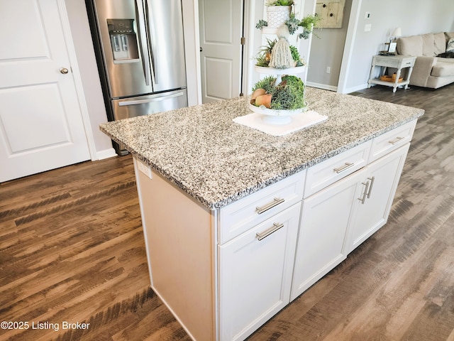 12630 Orell Station Pl, Louisville, KY 40272 - kitchen with stainless steel fridge with ice dispenser, light stone countertops, a center island, dark wood-style flooring, and white cabinets
