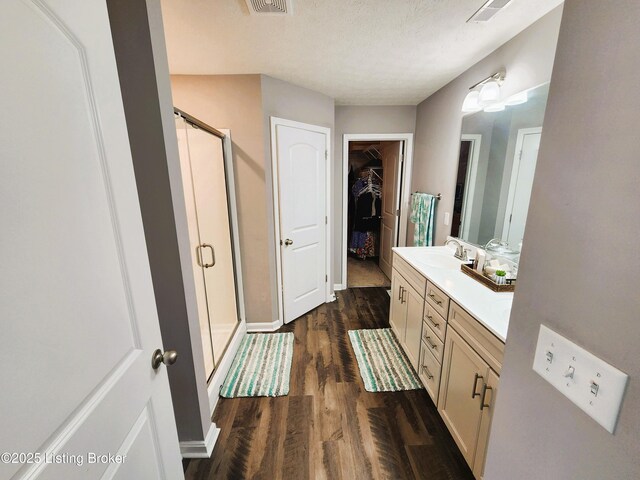 12630 Orell Station Pl, Louisville, KY 40272 - bathroom featuring a stall shower, vanity, wood finished floors, and a spacious closet